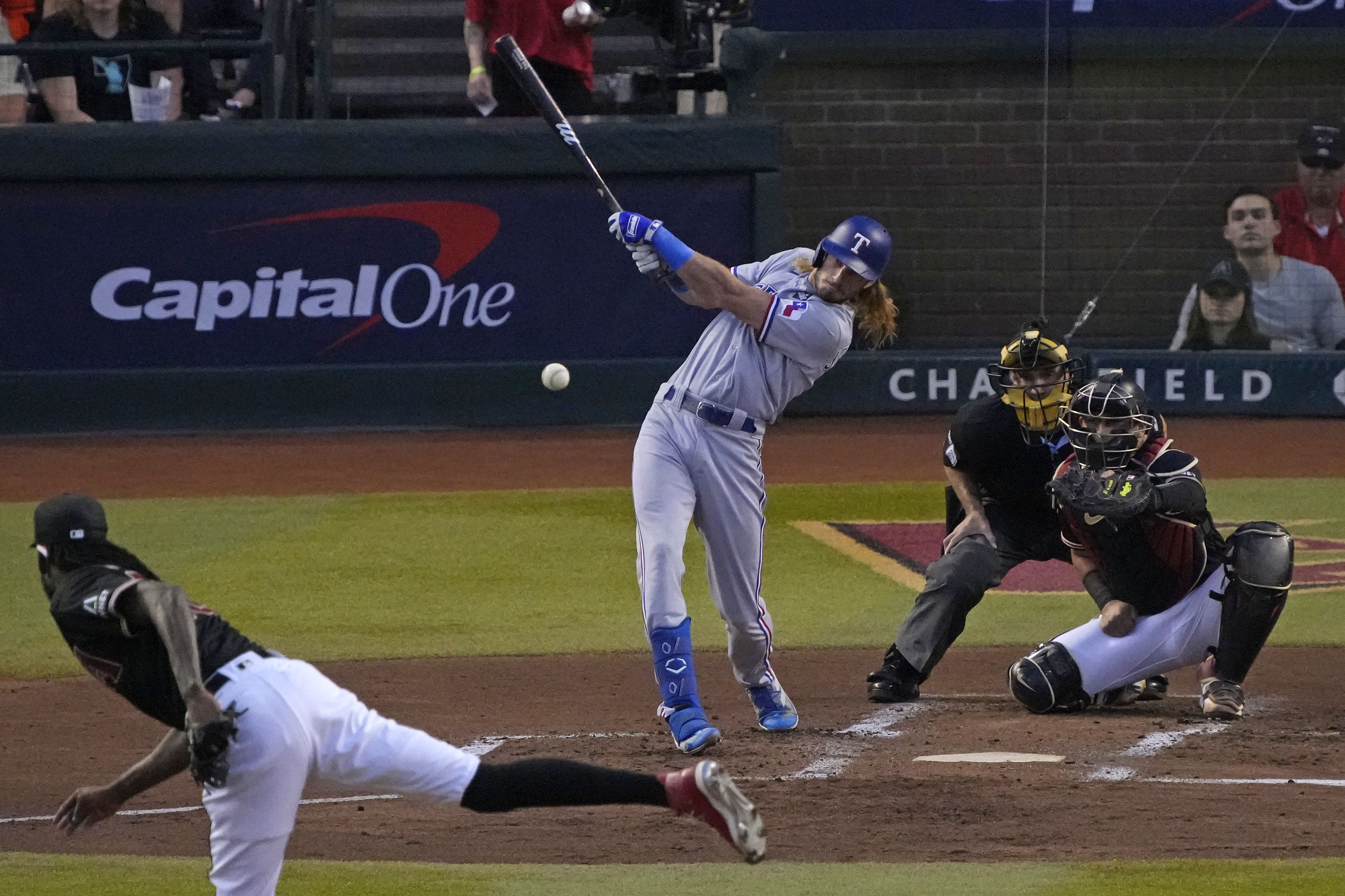 Oct 31, 2023; Phoenix, Arizona, USA; Texas Rangers left fielder Travis Jankowski (16) hits a single against the Arizona Diamondbacks during the second inning in game four of the 2023 World Series at Chase Field. Mandatory Credit: Rick Scuteri-USA TODAY Sports